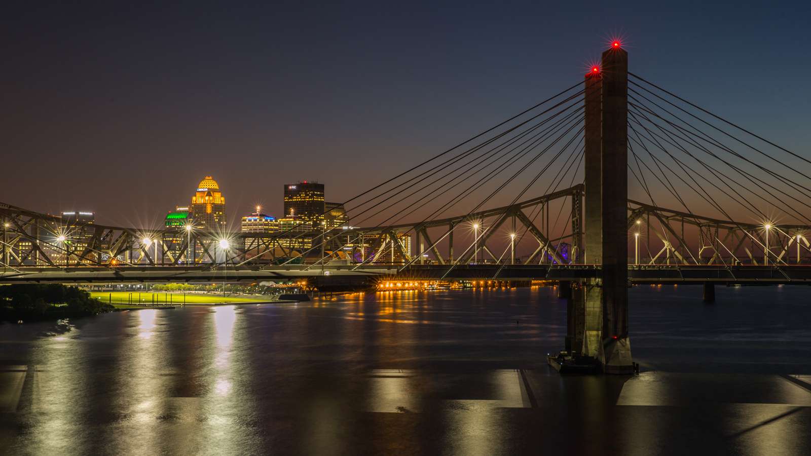 Showing the bridge downtown Louisville at night