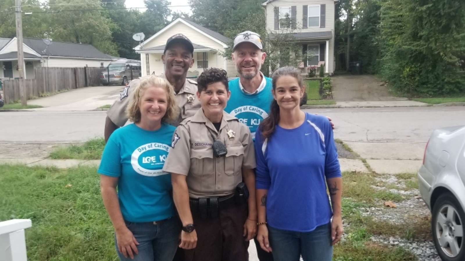 KU employees and sheriff deputy participating in community event