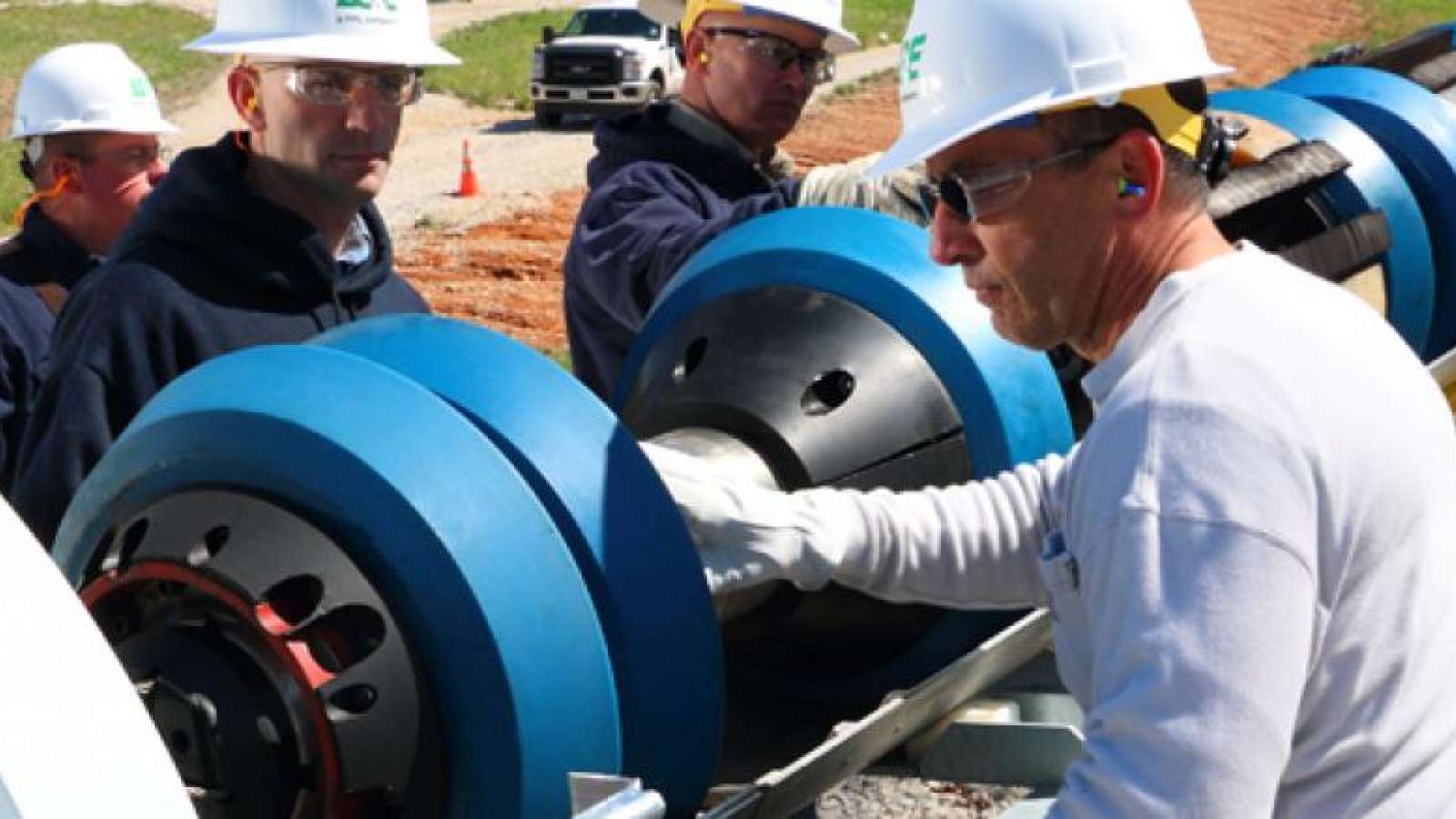 employees inspecting a gas pipeline