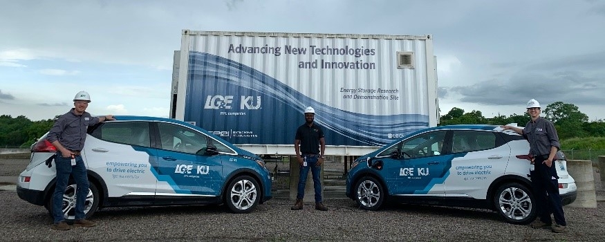 three employees with two electric vehicle and battery storage unit