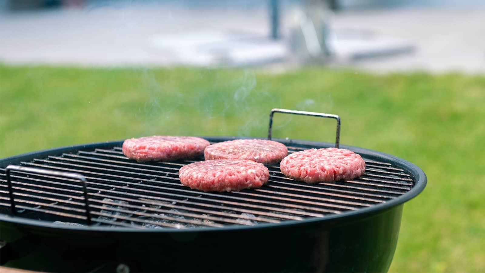 burgers being cooked on a grill