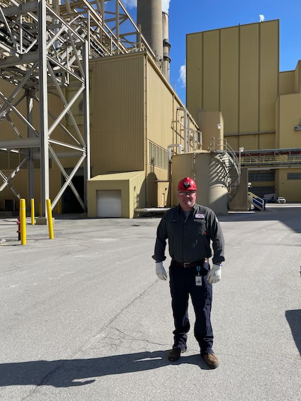 man standing in front of power plant