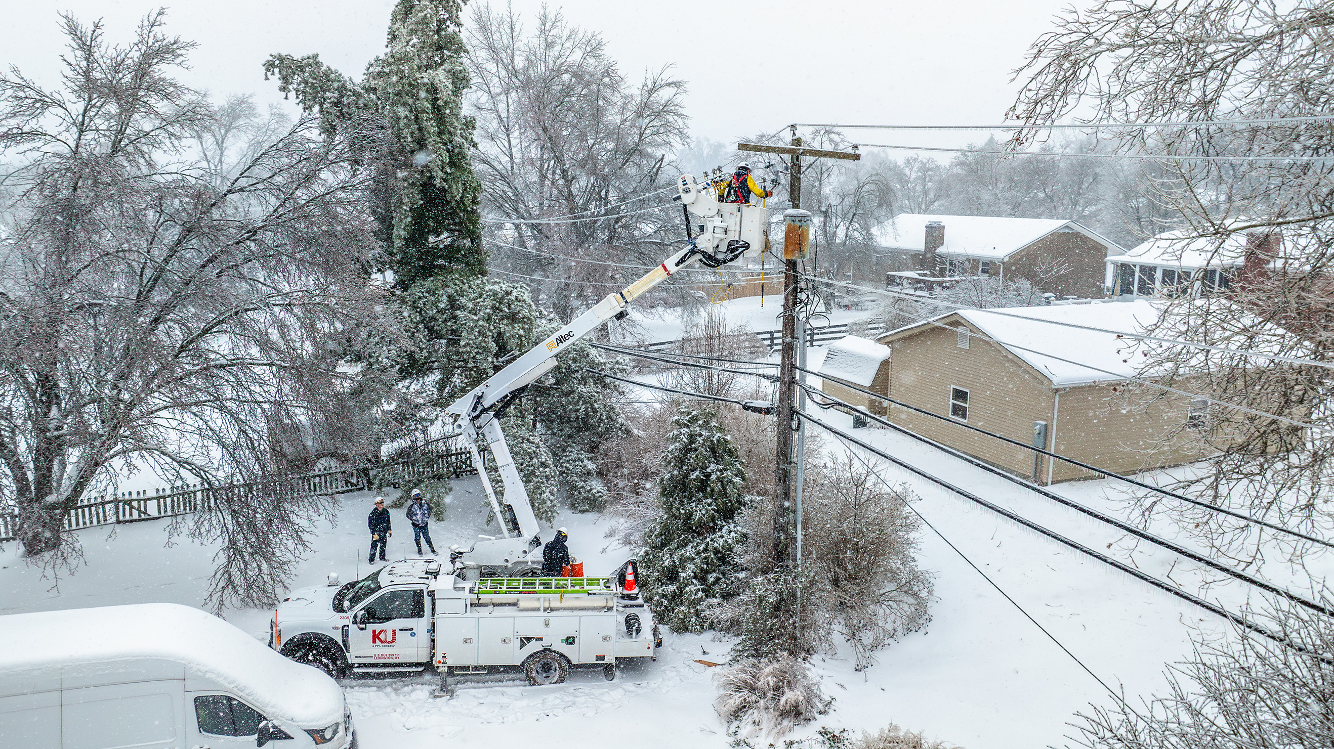 line technician in a bucket truck during ice storm