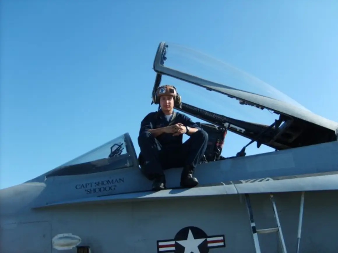 person sitting on cockpit of jet plane