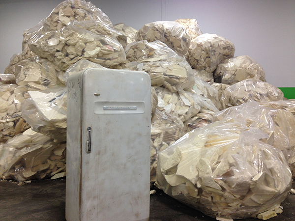 Insulation and refrigerants are removed from old refrigerators and freezers.
