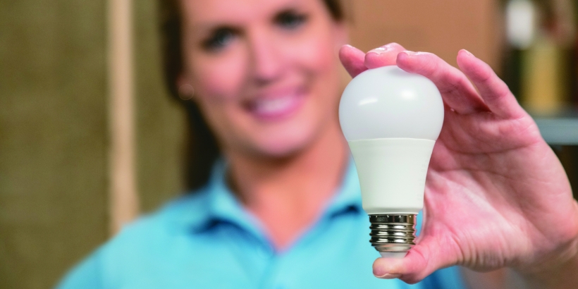 Woman holding light bulb.