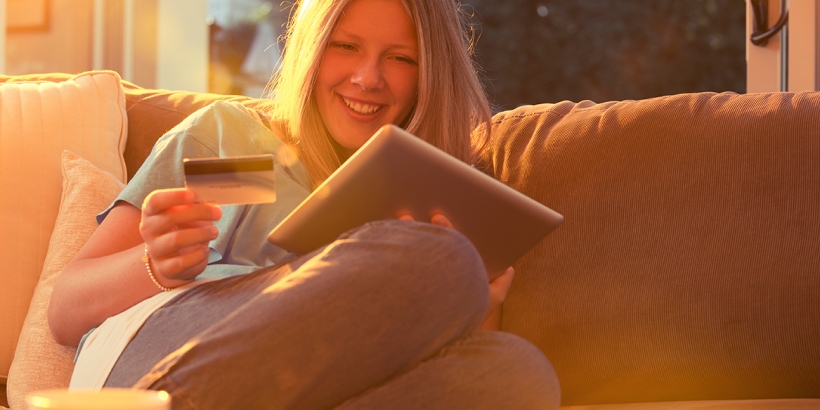Woman looking at tablet on sofa