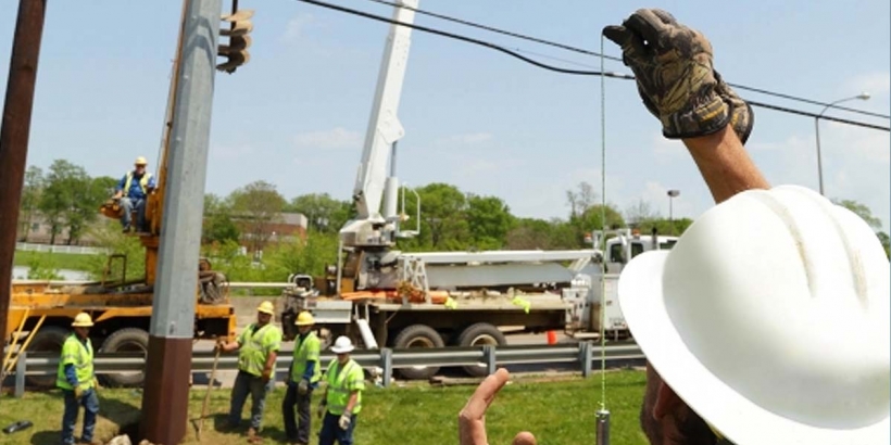 workers installing new power pole