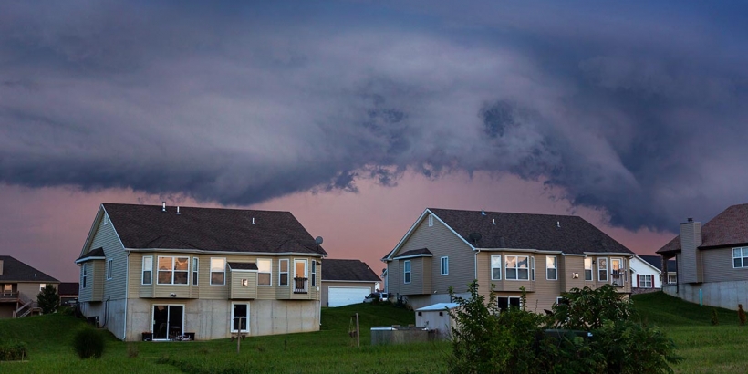homes with storm clouds above them