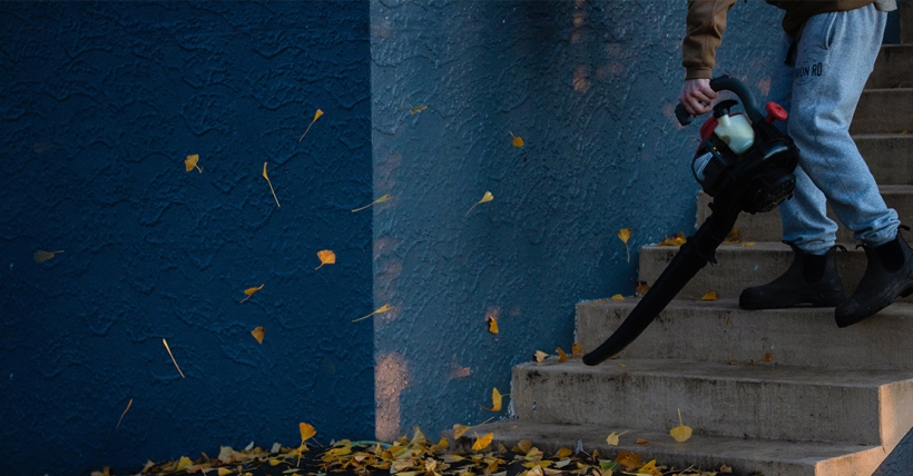 Man using leaf blower on stairs