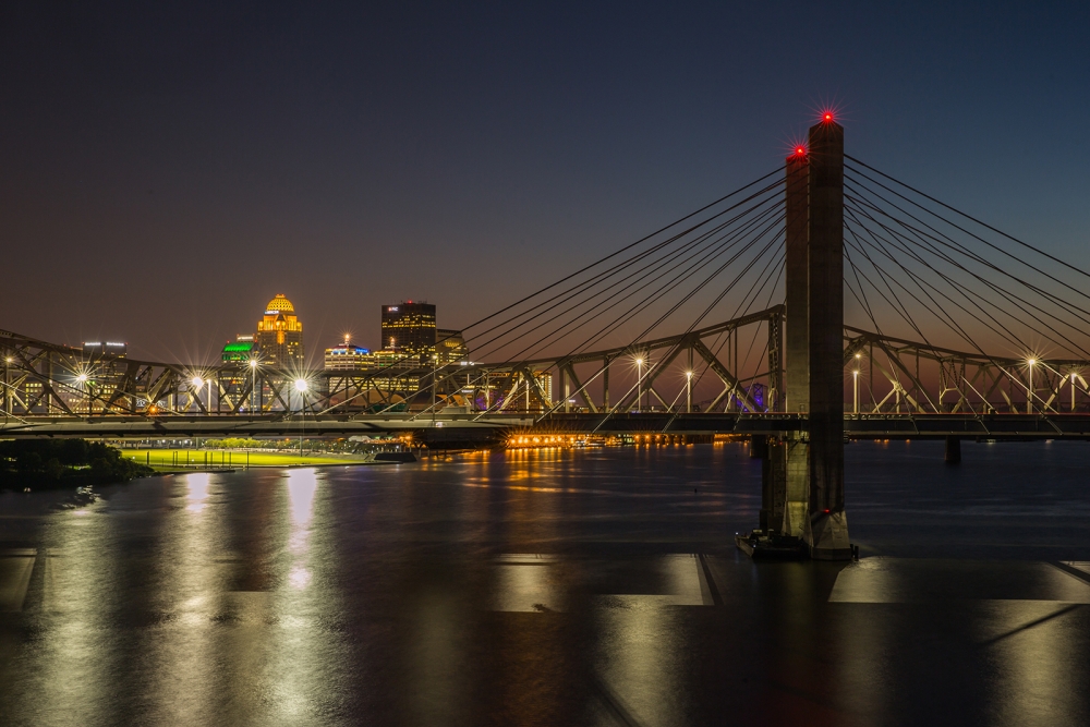 nighttime skyline shot of Lincoln Bridge with Louisville in background