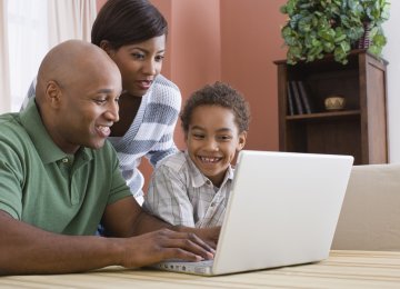 Family looking at laptop Family looking at laptop