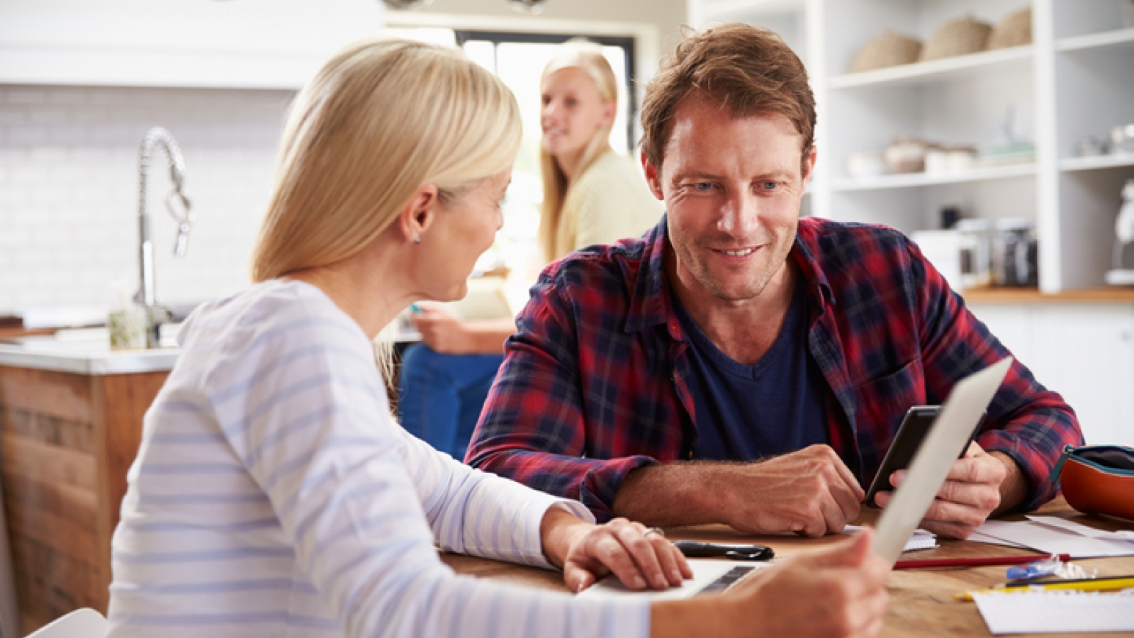 a couple at a table in their house going over finances