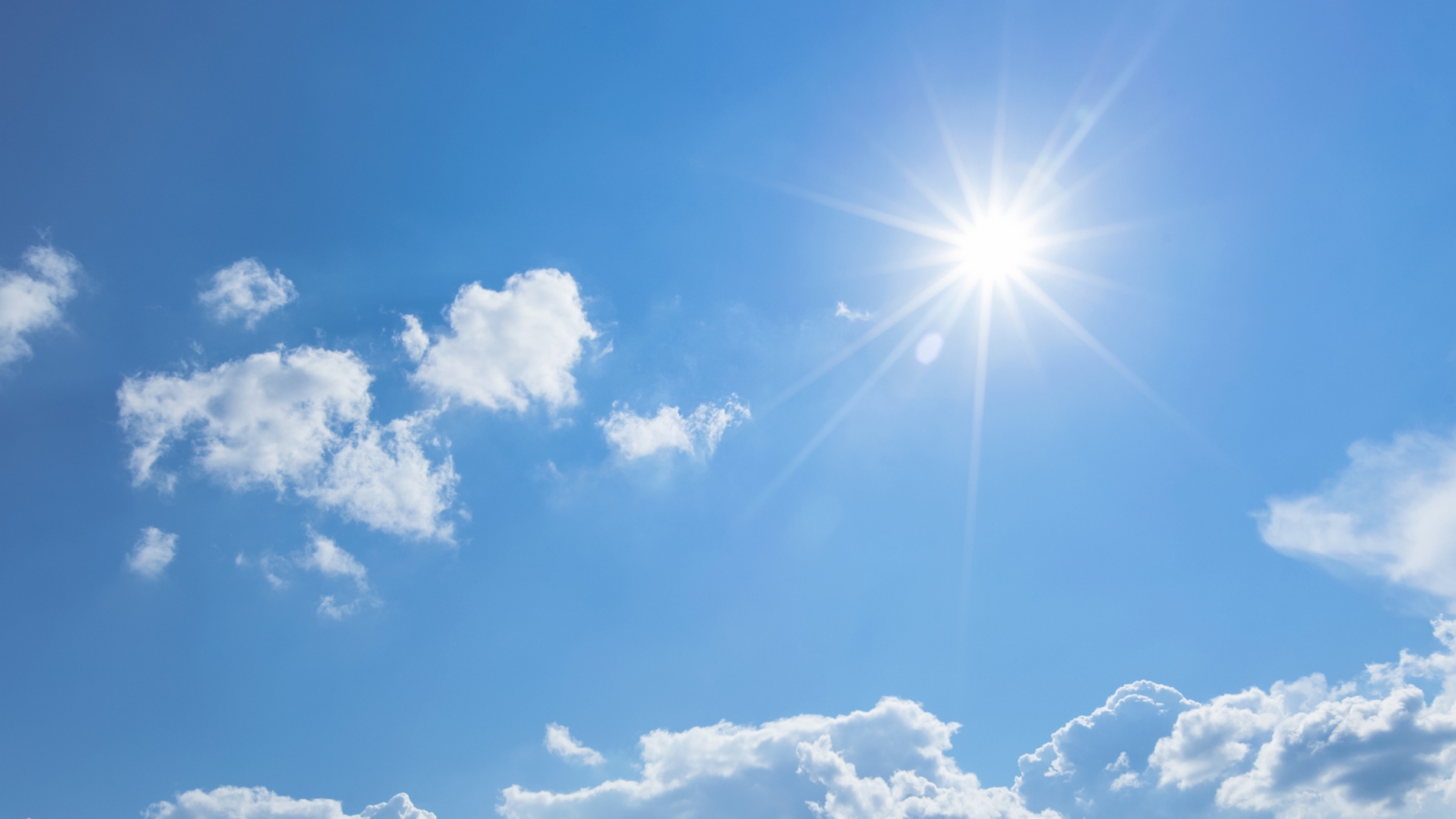 a sunny blue sky with a few clouds