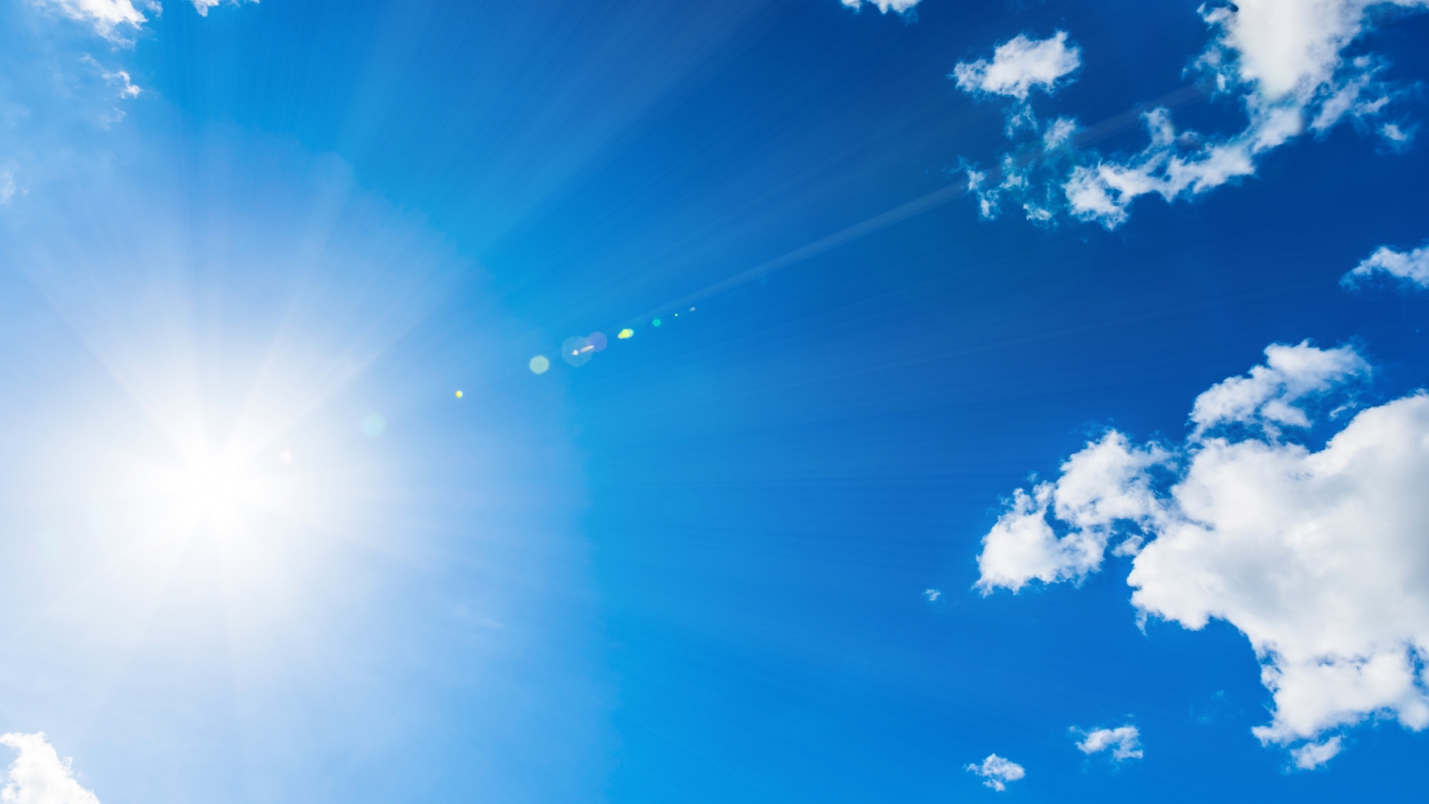 A sunny blue sky with a few clouds