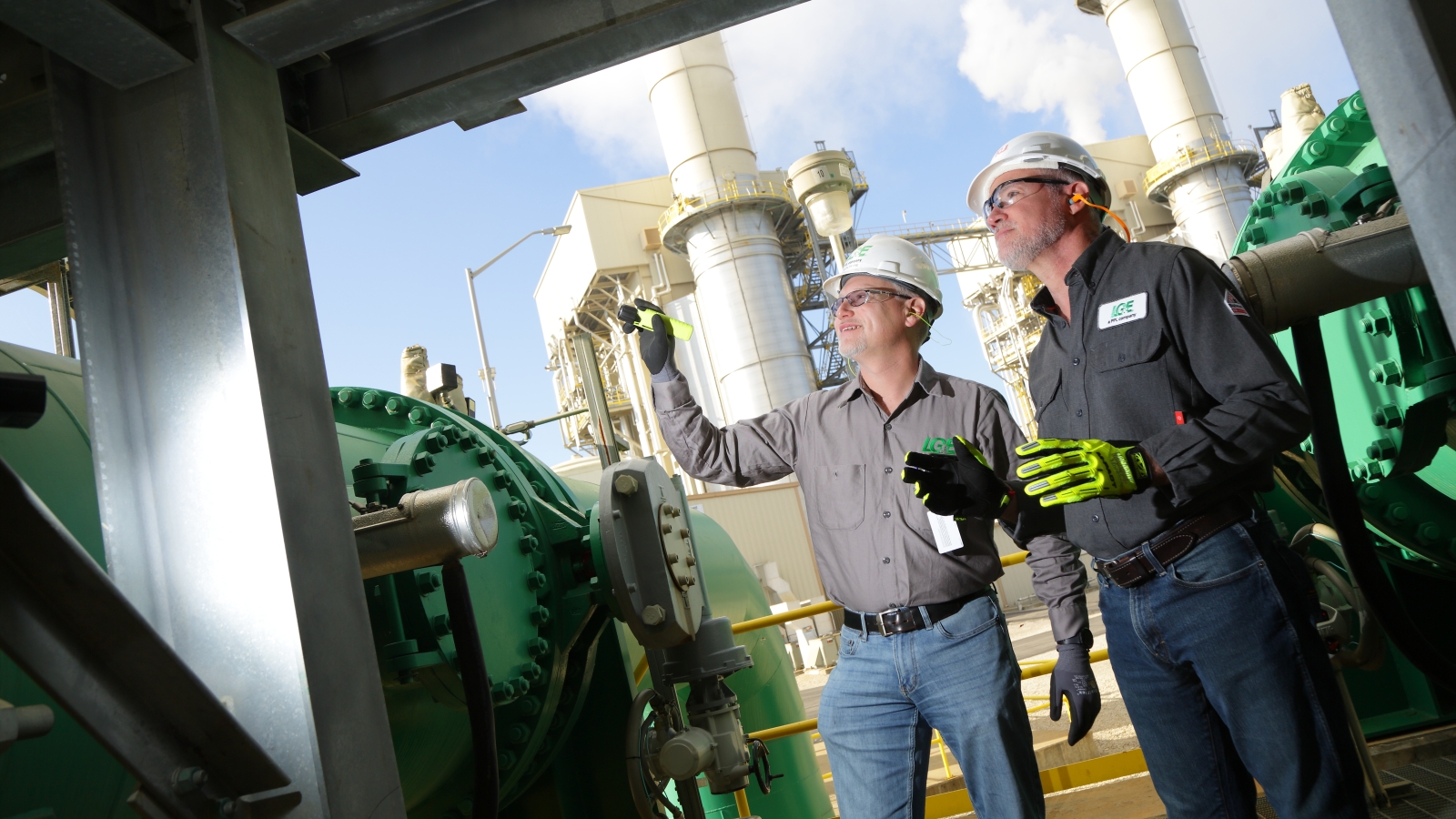 two employees looking up at a structure