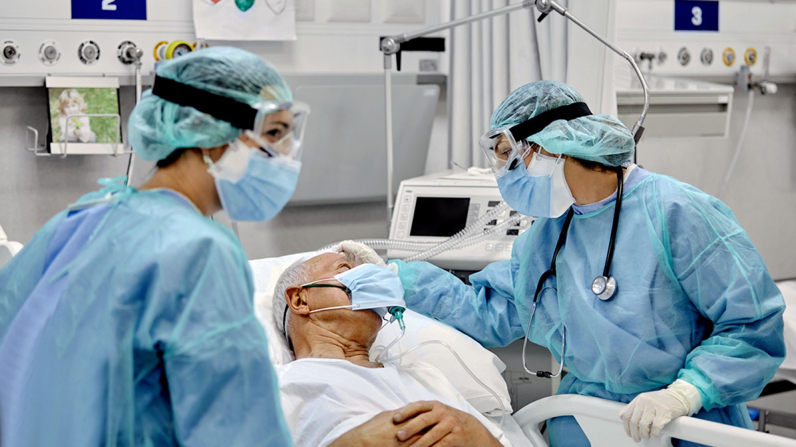 nurses caring for a patient in a hospital