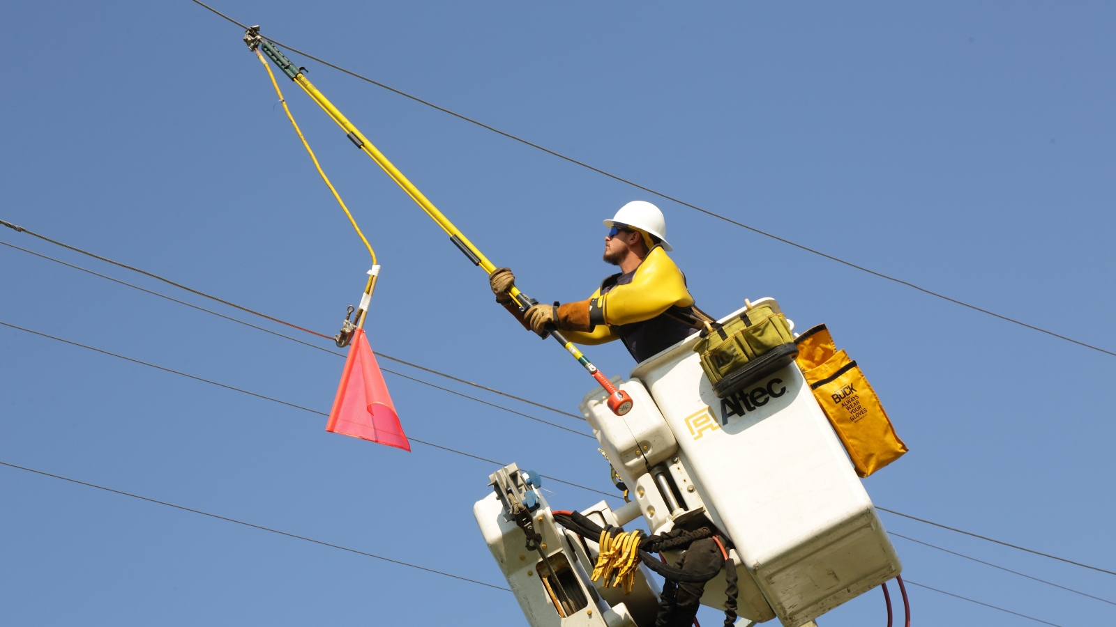 employee in bucket truck working on power lines