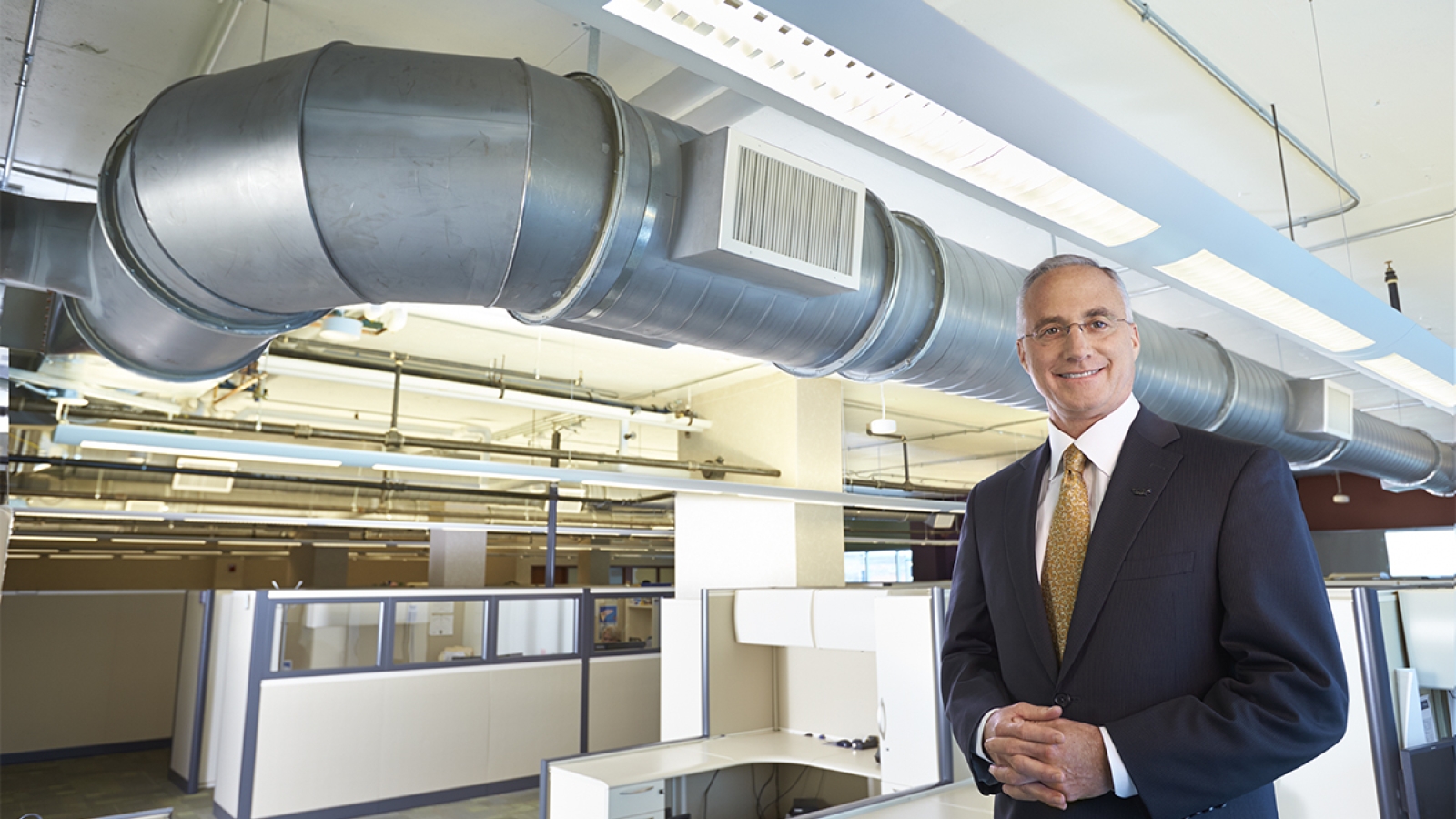 person standing in front of HVAC ducts