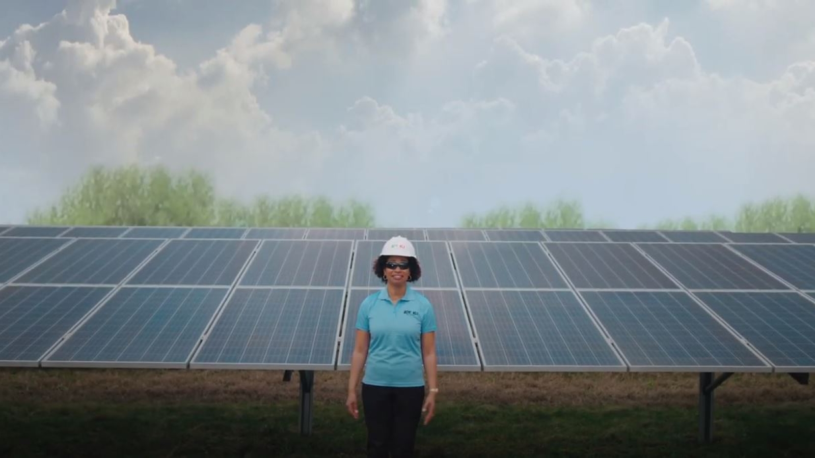 Employee standing in front of Solar Share array