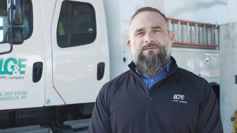 Employee in front of utility truck