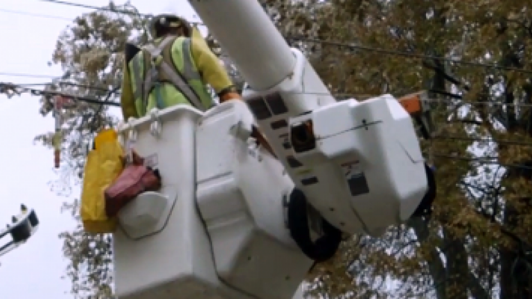 employee in a bucket being lifted into position