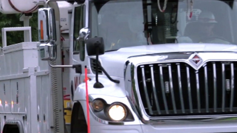 utility bucket truck moving toward camera