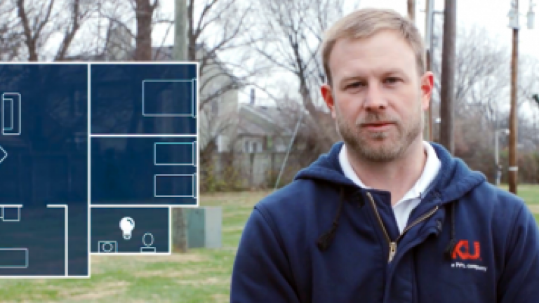 male employee with blueprint diagram of house on left side