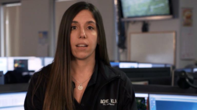 female employee in a room explaining estimated time of restoration