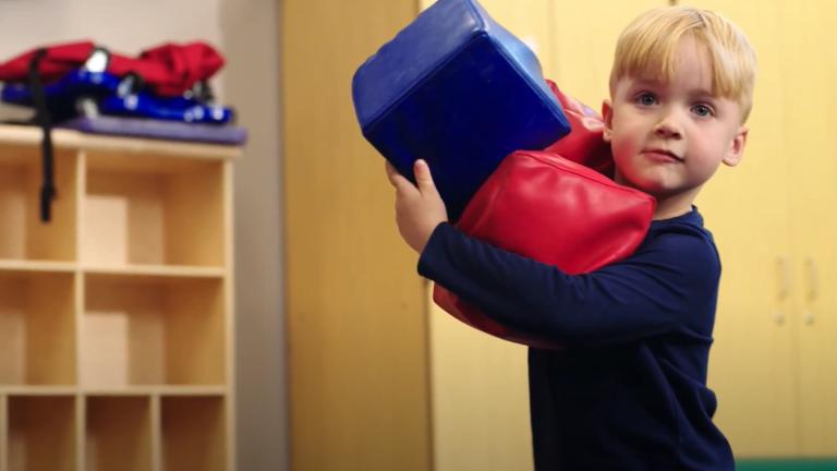 child carrying blocks