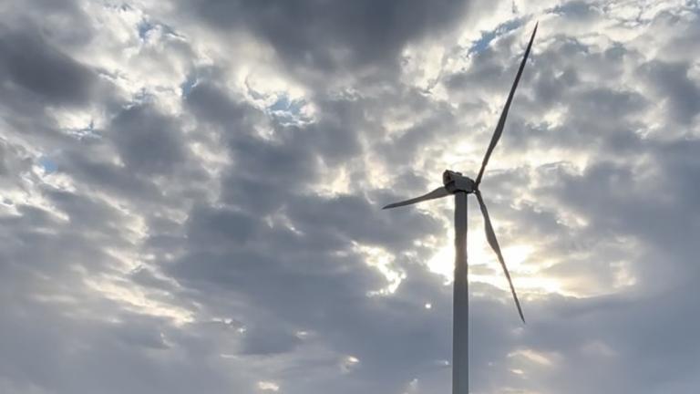 wind turbine under a cloudy sky