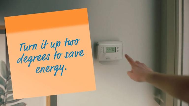Thermostat with Post-It-Note "Turn it up two degrees to save energy."