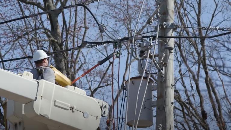 line technician in a bucket truck working on a power line