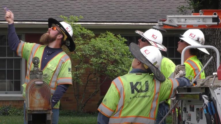 utility workers assessing damage