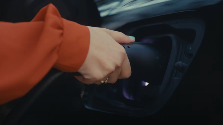 hand pulling an EV charger connector from a car