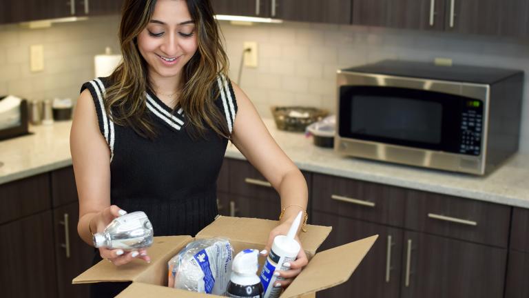 person opening box with energy saving items