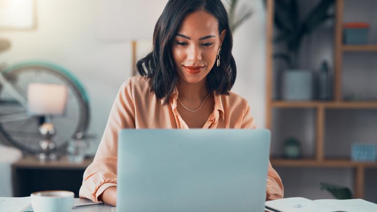 person at desk with laptop