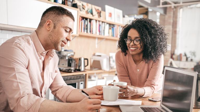 Couple looking at paperwork and laptop