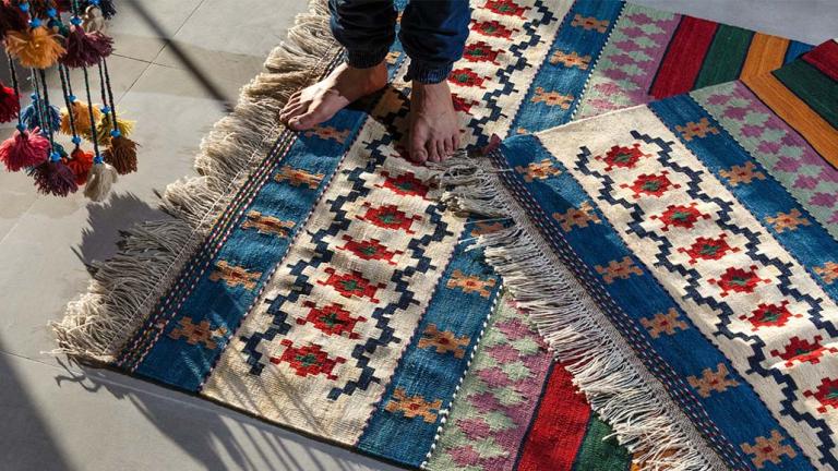 Person with bear feet standing on rug