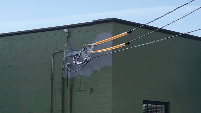 cover drop on a power line outside of a building