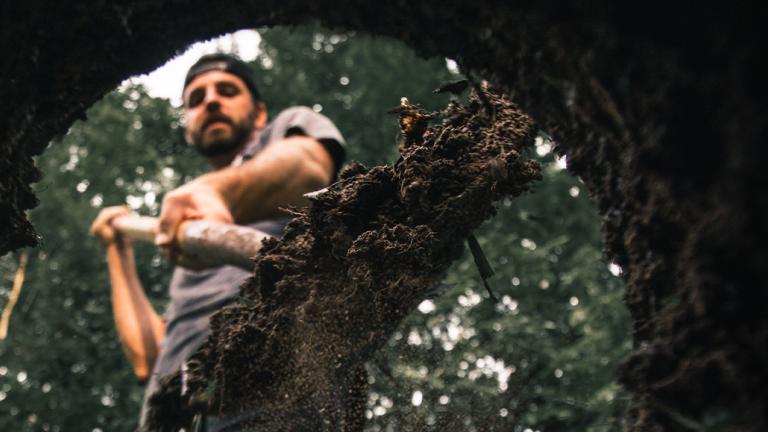 man digging hole from perspective of the hole