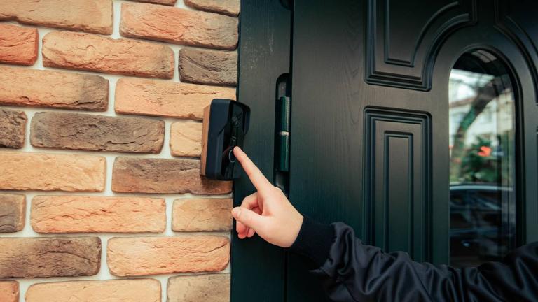 person ringing a doorbell