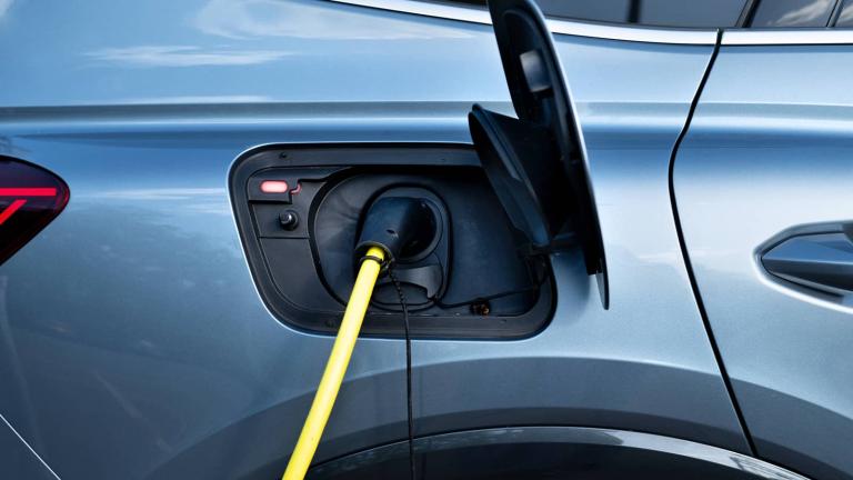 An electric vehicle with a charger connected to it.