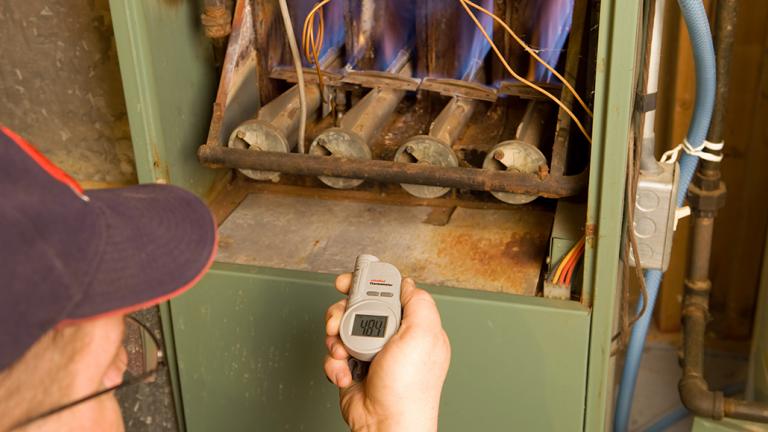 Person checking heating system