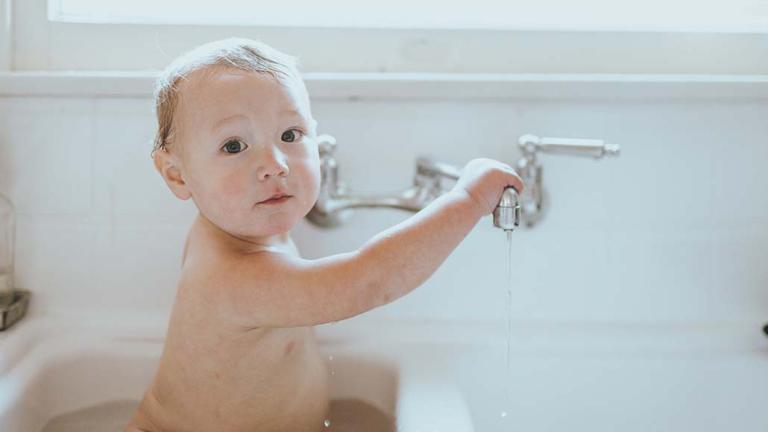 Baby in bathing in a sink
