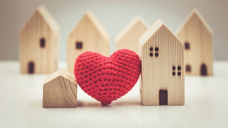 a knit heart among wooden block houses