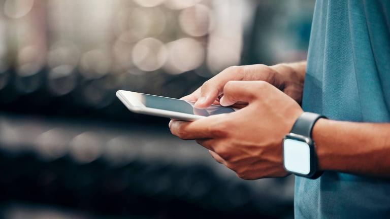 closeup of hands typing on a mobile device