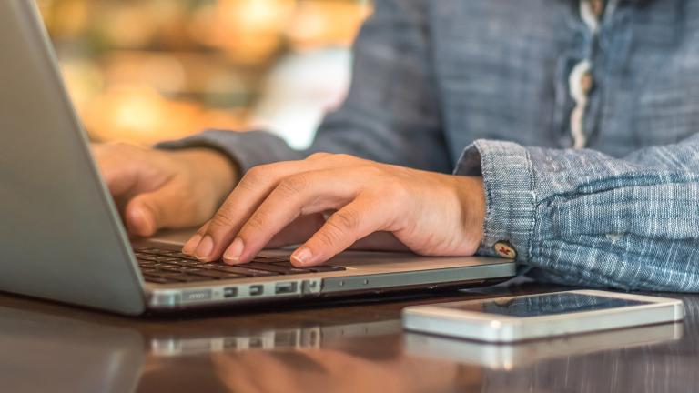 person typing on a laptop