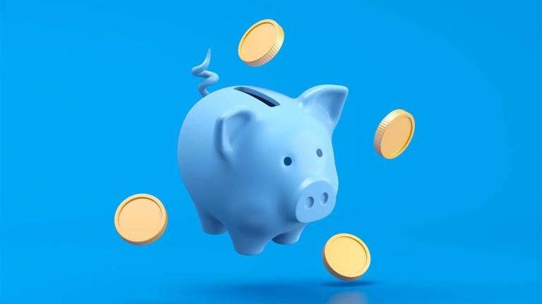 piggy bank with coins surrounding it