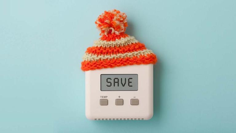 thermostat that reads save, with a knit cap on top